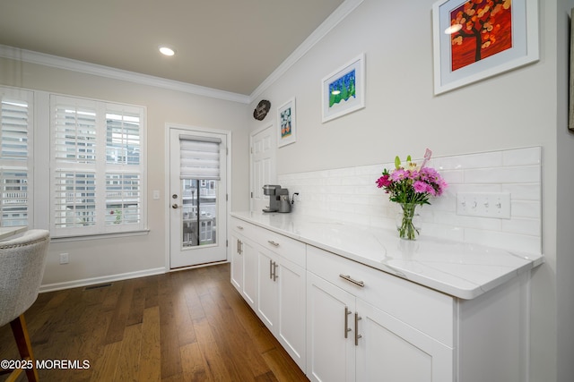 doorway to outside featuring ornamental molding, dark wood-type flooring, recessed lighting, and baseboards
