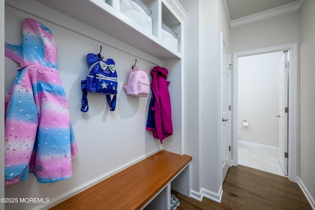mudroom with crown molding and baseboards