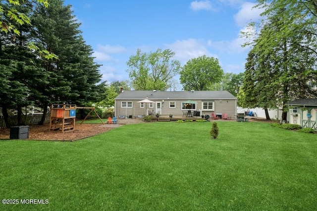 back of property with a playground, a chimney, and an outdoor structure