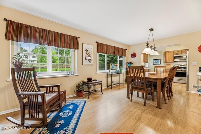 dining room with light wood-style flooring and baseboards