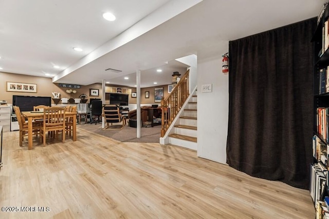 living room with light wood-style flooring, stairs, and recessed lighting
