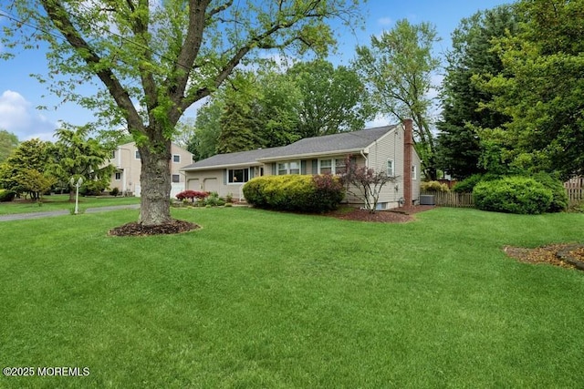 view of front of home featuring a chimney and an attached garage