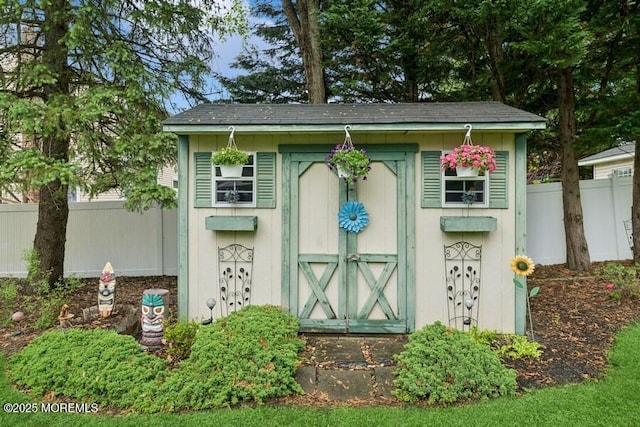 view of shed featuring fence