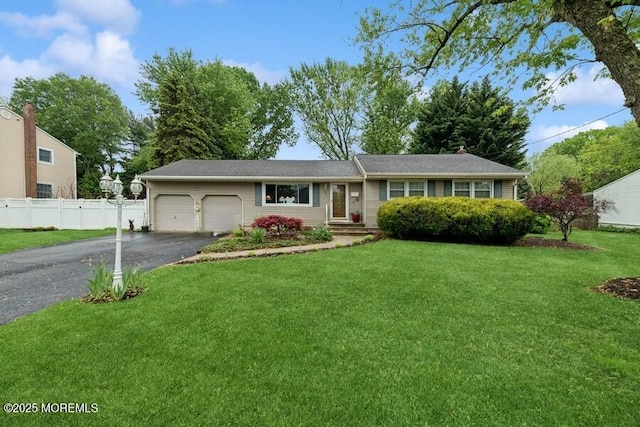 ranch-style home featuring a garage and driveway