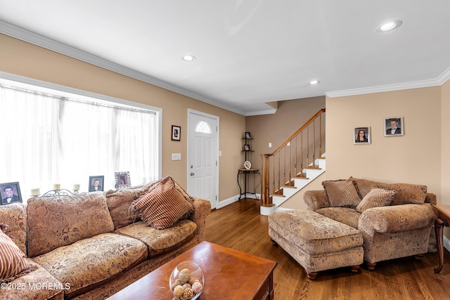 living area featuring ornamental molding, recessed lighting, wood finished floors, baseboards, and stairs