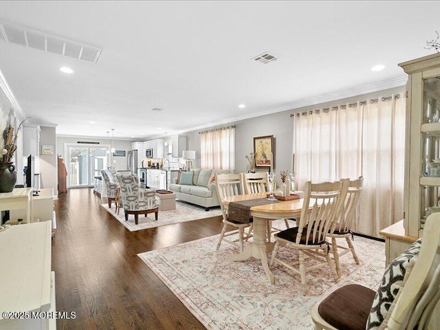 dining room with crown molding, dark wood-type flooring, and recessed lighting