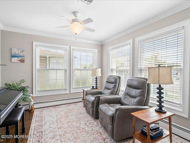 living area with a baseboard radiator, a ceiling fan, crown molding, wood finished floors, and baseboards