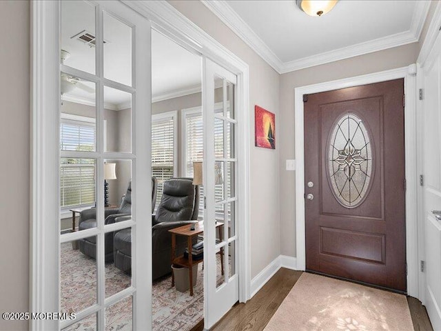 entryway featuring ornamental molding, dark wood finished floors, baseboards, and french doors