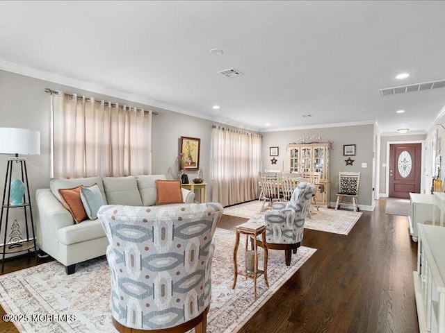 living area featuring wood finished floors, crown molding, recessed lighting, and baseboards