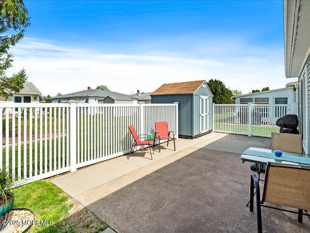 view of patio / terrace with a storage shed, an outbuilding, and fence