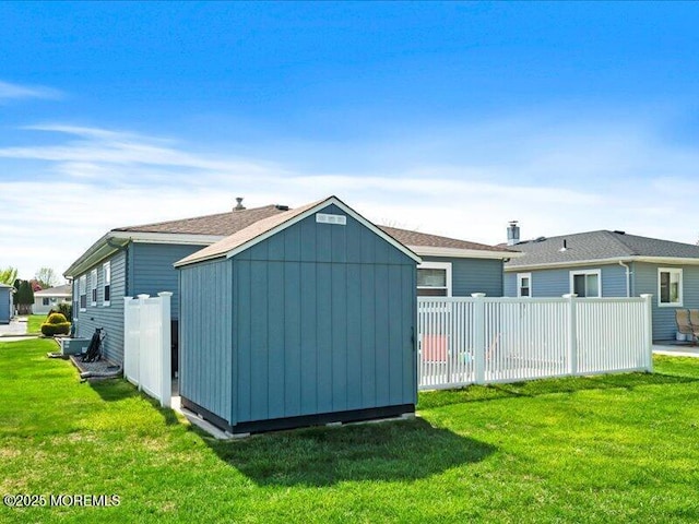 back of property featuring a storage unit and an outdoor structure