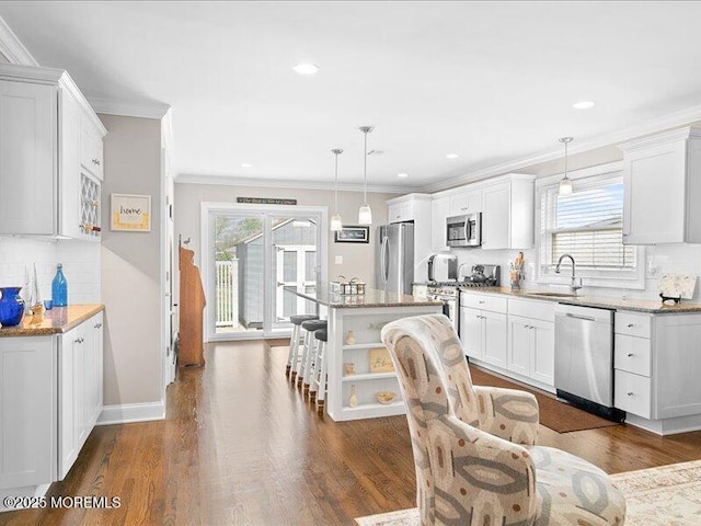 kitchen featuring stainless steel appliances, plenty of natural light, ornamental molding, decorative backsplash, and open shelves