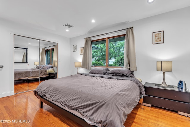 bedroom featuring a closet, light wood-style floors, and recessed lighting