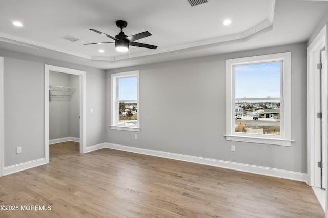 42 W Mohawk Dr, Little Egg Harbor, NJ 08087 - unfurnished bedroom featuring a tray ceiling, crown molding, light wood-style flooring, a walk in closet, and recessed lighting