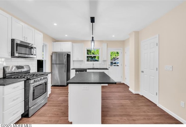 1031 3rd Ave, Asbury Park, NJ 07712 - kitchen with appliances with stainless steel finishes, dark countertops, decorative backsplash, white cabinetry, and recessed lighting