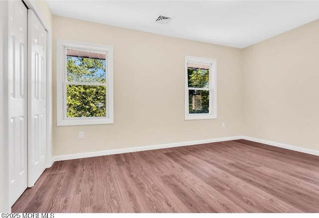 1031 3rd Ave, Asbury Park, NJ 07712 - unfurnished bedroom featuring wood finished floors, baseboards, and a closet