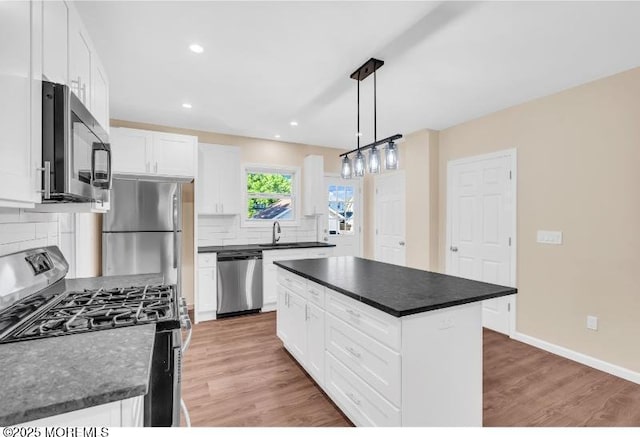 1031 3rd Ave, Asbury Park, NJ 07712 - kitchen with appliances with stainless steel finishes, a sink, decorative backsplash, dark countertops, and recessed lighting
