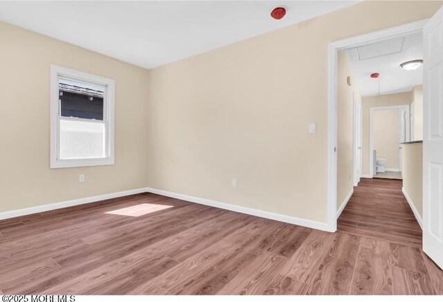 1031 3rd Ave, Asbury Park, NJ 07712 - unfurnished room with attic access, light wood-type flooring, and baseboards