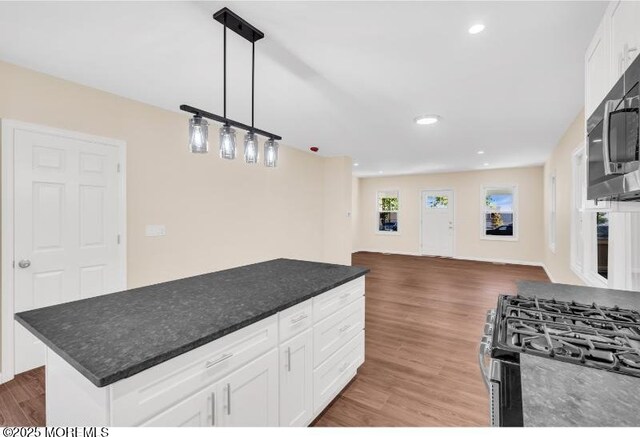 1031 3rd Ave, Asbury Park, NJ 07712 - kitchen with stainless steel appliances, white cabinets, wood finished floors, open floor plan, and recessed lighting