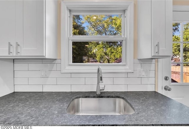 1031 3rd Ave, Asbury Park, NJ 07712 - kitchen view of a sink, dark stone countertops, white cabinets, and decorative backsplash