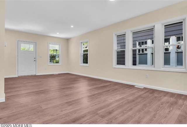 1031 3rd Ave, Asbury Park, NJ 07712 - unfurnished living room featuring baseboards, light wood-style flooring, and recessed lighting