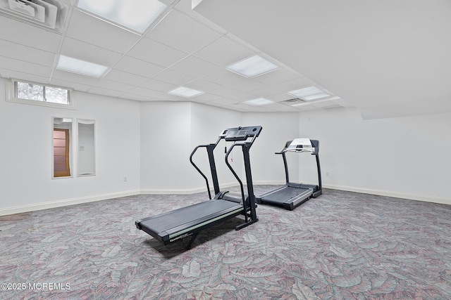exercise area with carpet flooring, a drop ceiling, and baseboards