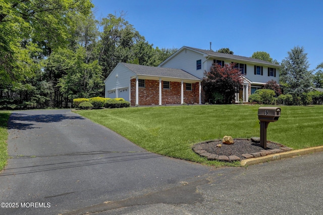 5 Eagle Hill Rd, Holmdel, NJ 07733 - traditional-style house with a front lawn, an attached garage, and brick siding