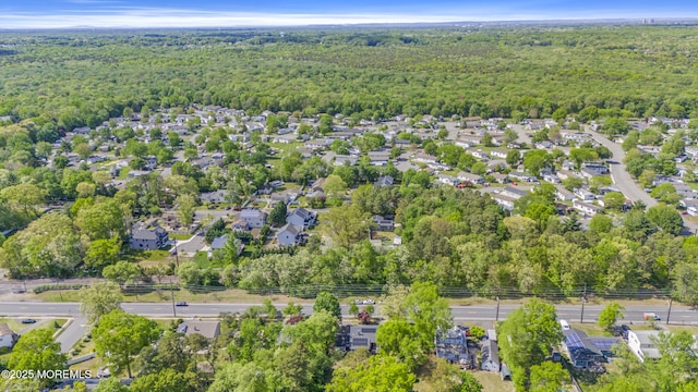 aerial overview of property's location with a heavily wooded area