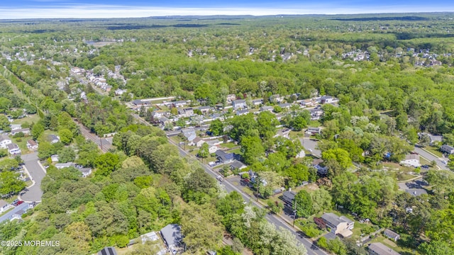 aerial view of property's location with a heavily wooded area