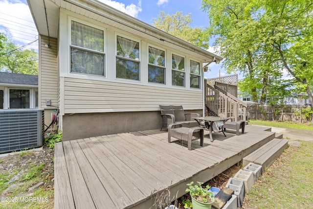 wooden deck with central AC unit, fence, and stairs
