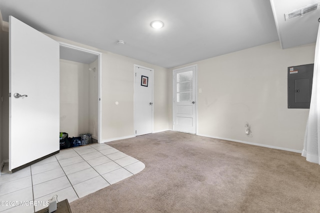 empty room with electric panel, light carpet, baseboards, and a smoke detector