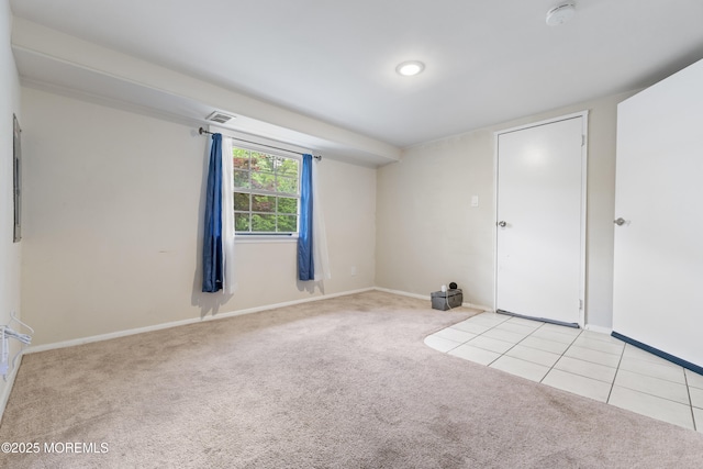 spare room featuring light colored carpet, a smoke detector, and baseboards