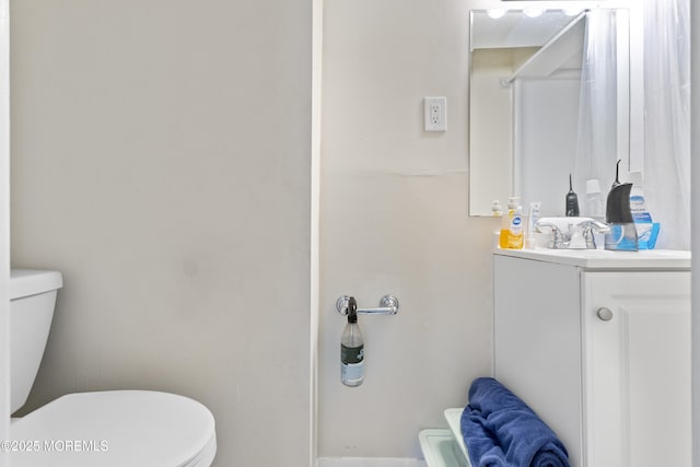 bathroom featuring toilet and vanity