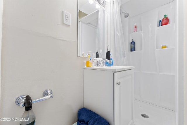 bathroom featuring a stall shower and vanity