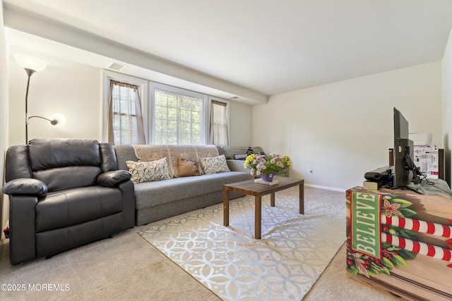 carpeted living room with baseboards