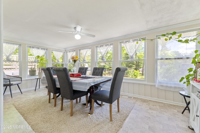 sunroom / solarium featuring ornamental molding and baseboards