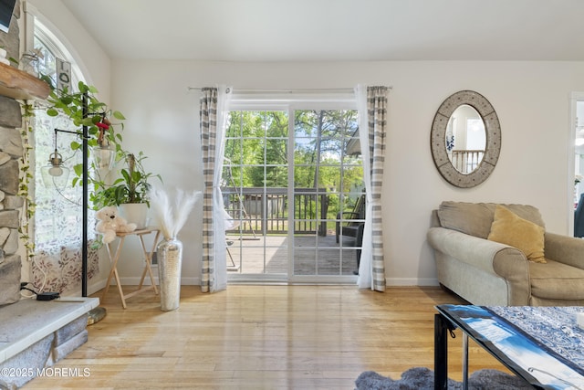 entryway with wood finished floors and baseboards