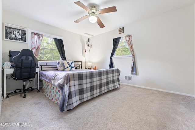 carpeted bedroom featuring ceiling fan and baseboards