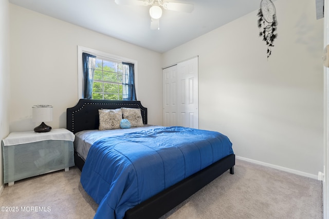 carpeted bedroom with baseboards, a closet, and a ceiling fan