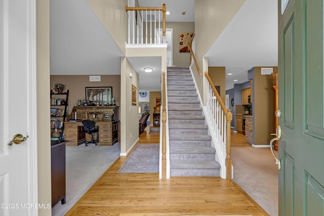 13 Dori Ln, Barnegat, NJ 08005 - entryway featuring stairs, a high ceiling, light carpet, baseboards, and light wood finished floors