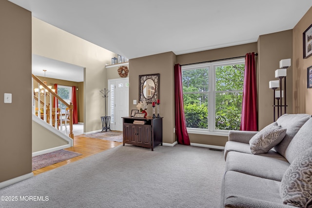 13 Dori Ln, Barnegat, NJ 08005 - living room with stairs, light carpet, a chandelier, and baseboards