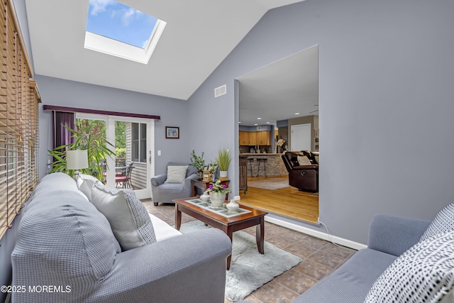 13 Dori Ln, Barnegat, NJ 08005 - tiled living room featuring high vaulted ceiling, a skylight, and baseboards