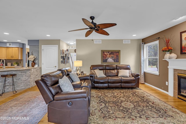 13 Dori Ln, Barnegat, NJ 08005 - living room with a ceiling fan, a tiled fireplace, light wood-style flooring, recessed lighting, and baseboards