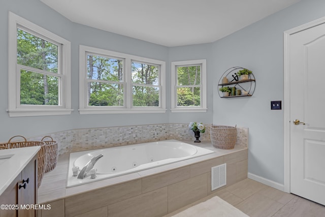 13 Dori Ln, Barnegat, NJ 08005 - bathroom with plenty of natural light, a whirlpool tub, vanity, and baseboards
