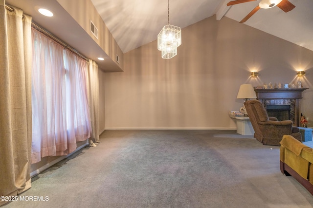 unfurnished living room with a fireplace, ceiling fan, carpet floors, beam ceiling, and a chandelier