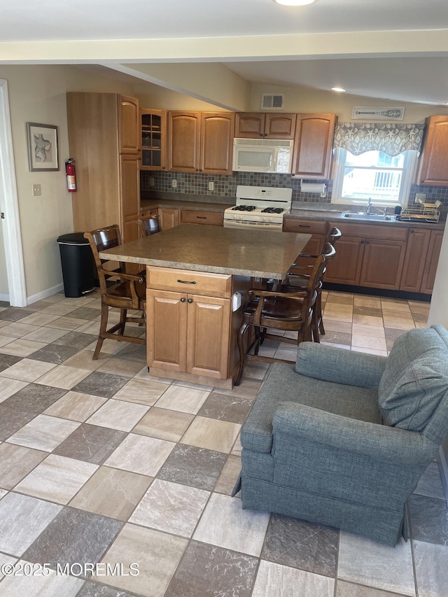 100 Vance Ave, Lavallette, NJ 08735 - kitchen featuring white appliances, tasteful backsplash, a kitchen breakfast bar, and a sink
