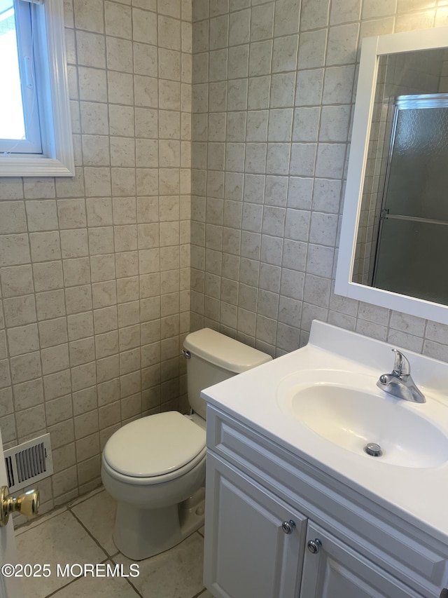 100 Vance Ave, Lavallette, NJ 08735 - bathroom featuring tile walls, tile patterned flooring, toilet, vanity, and a shower with door