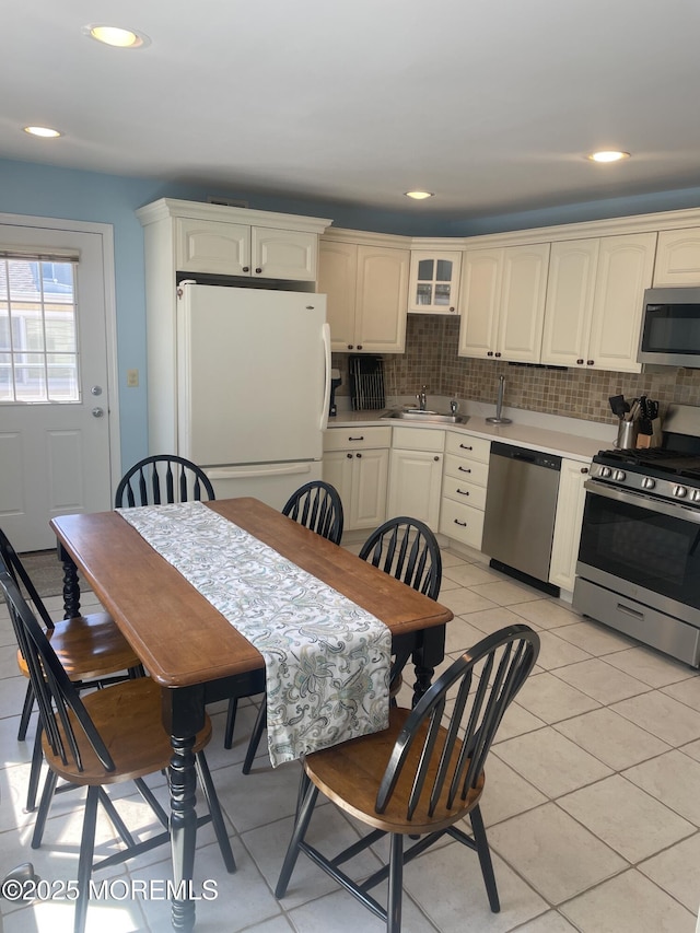 100 Vance Ave, Lavallette, NJ 08735 - kitchen with appliances with stainless steel finishes, a sink, backsplash, light countertops, and light tile patterned floors