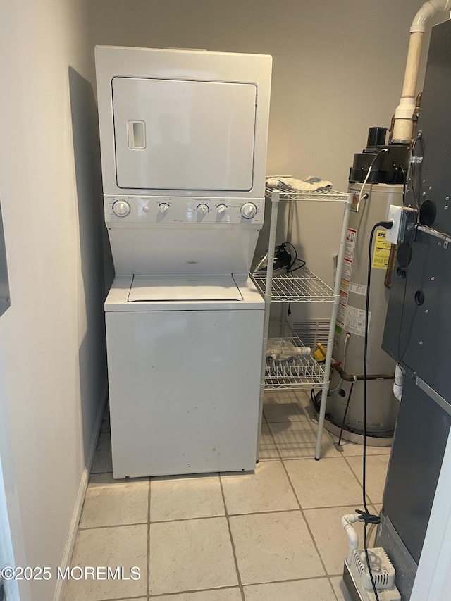 100 Vance Ave, Lavallette, NJ 08735 - clothes washing area featuring estacked washer and dryer, water heater, light tile patterned floors, and baseboards