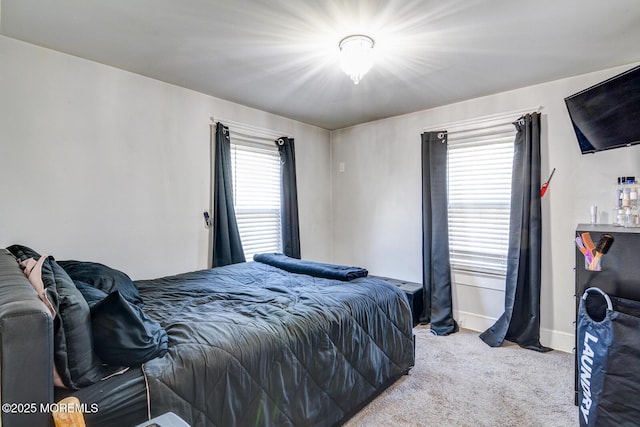 bedroom with carpet floors and baseboards
